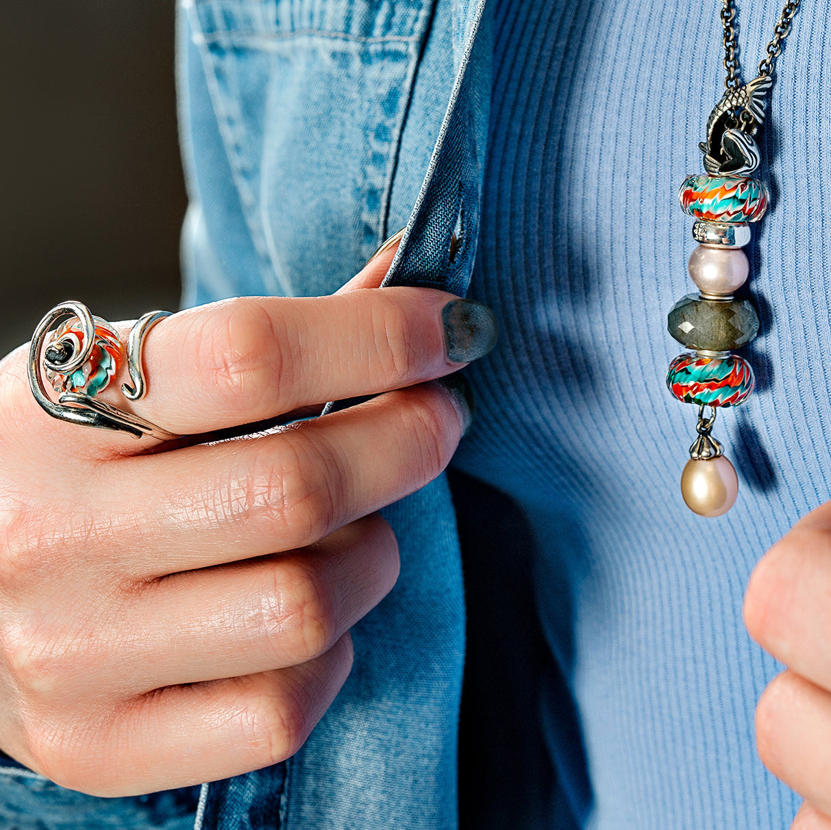 Model in blue clothes wearing carp koi jewelry beads on a fantasy necklace, with pearls and labradorite